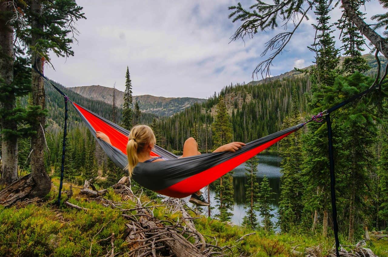 Girl Outdoors in a hammock. Hiking in the woods. Asheville Dental.