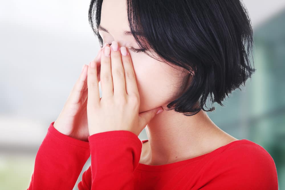 Young Asian woman sinus infection toothache pain and pressure