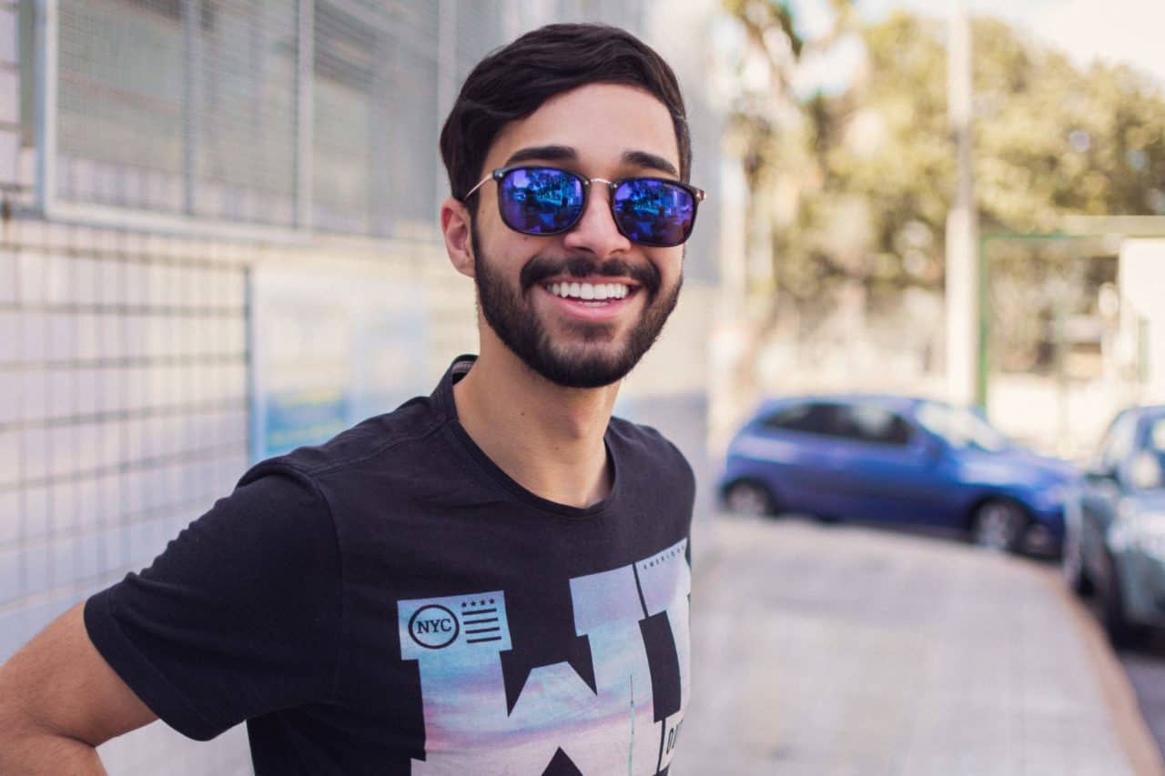 Adult man teeth whitening smile sunglasses bearded urban setting
