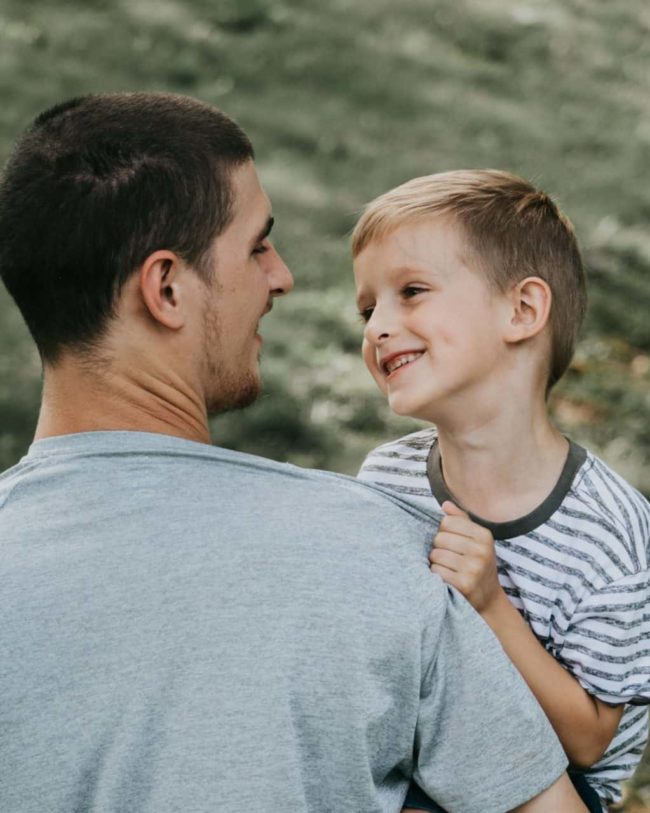 Is Sedation Dentistry Right for Me? Is It Safe for My Child? Dad holding son outdoors smiling.