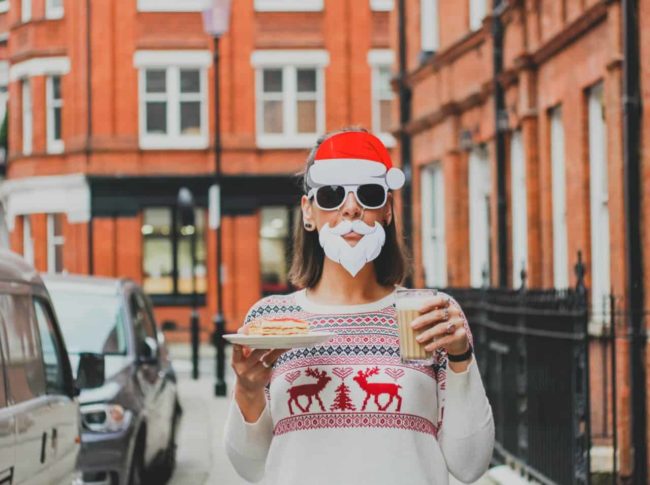 Woman with santa beard and milk and cookies