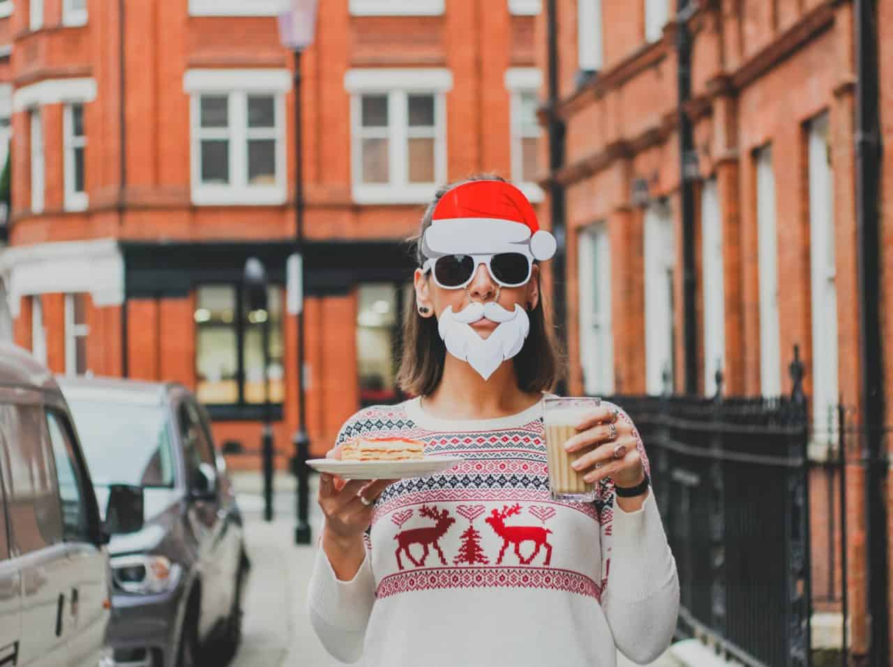 Woman with santa beard and milk and cookies