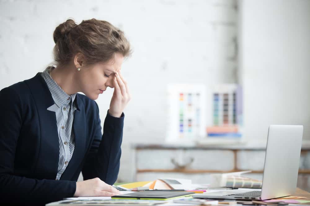 Woman at work with headache