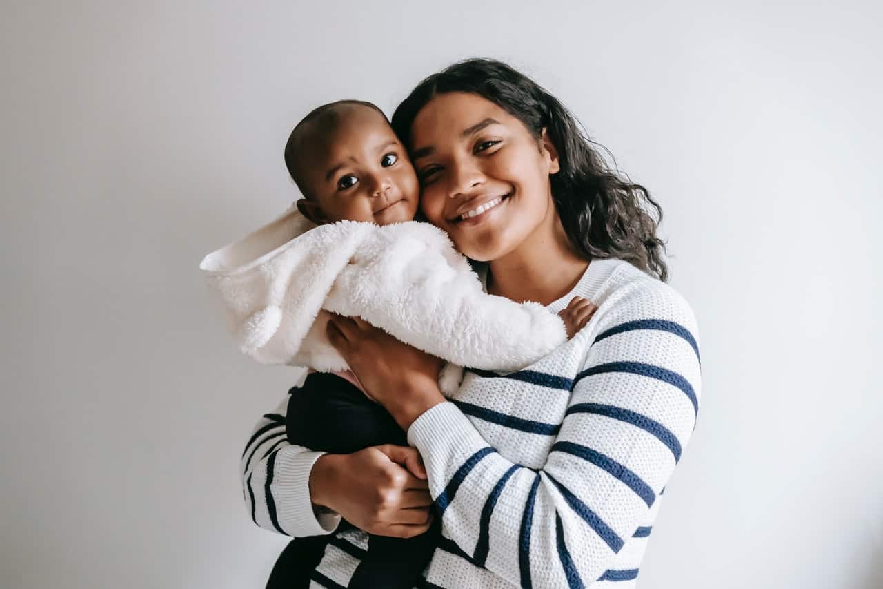 Brown mother holding a young brown baby