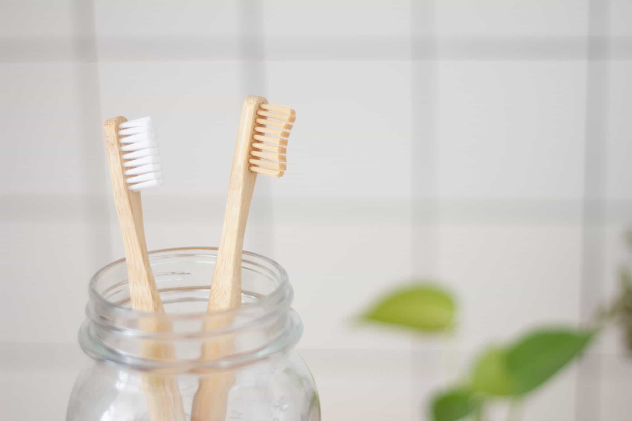 bamboo toothbrushes in glass jar