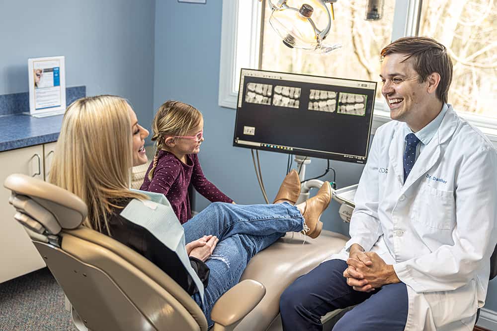 Dr. Dasher thoughtfully explaining treatment to patients.