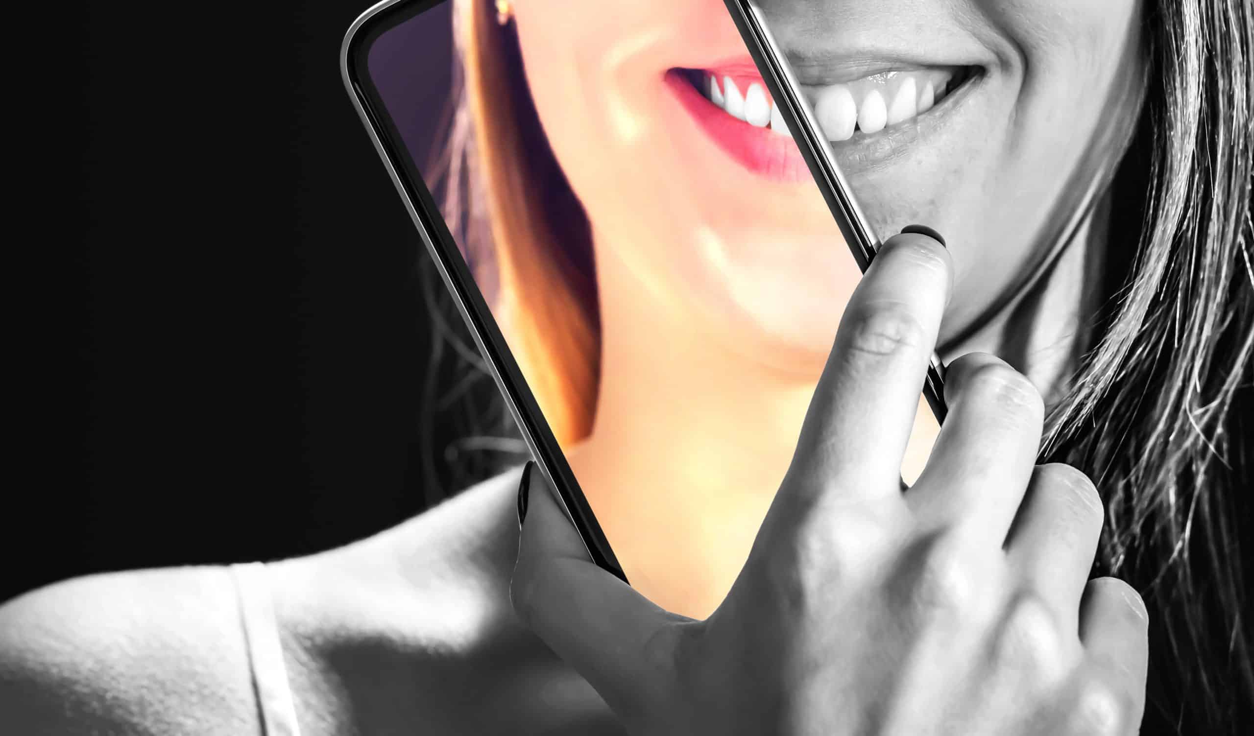 woman holding cell phone filter for whiter teeth