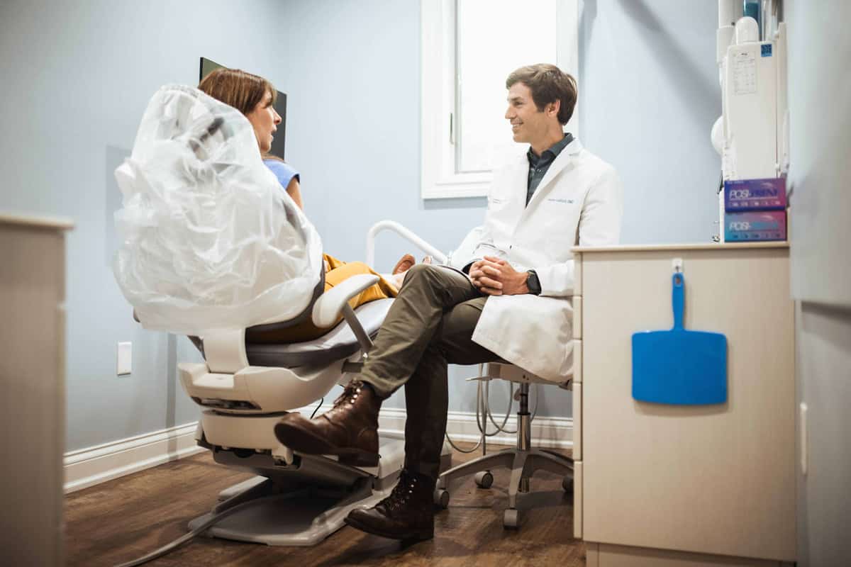 Dr. Ledford speaking with a female dental patient